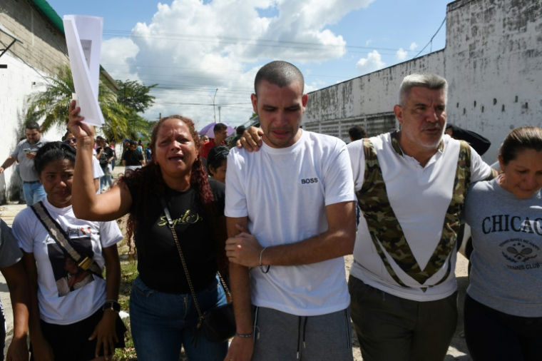 Un homme arrêté lors des manifestations qui ont suivi la réélection de Nicolas Maduro marche à côté de ses proches après sa libération de la prison de Tocuyito, dans l'Etat de Carabobo, au Venezuela, le 16 novembre 2024 ( AFP / Gabriela Perez )