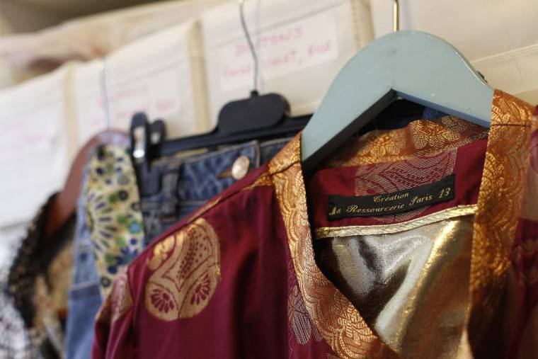 De nouveaux vêtements créés à partir d'anciens sont exposés à la brocante "Ma Ressourcerie", située dans le 13e arrondissement de Paris, le 28 août 2015. ( AFP / THOMAS SAMSON )