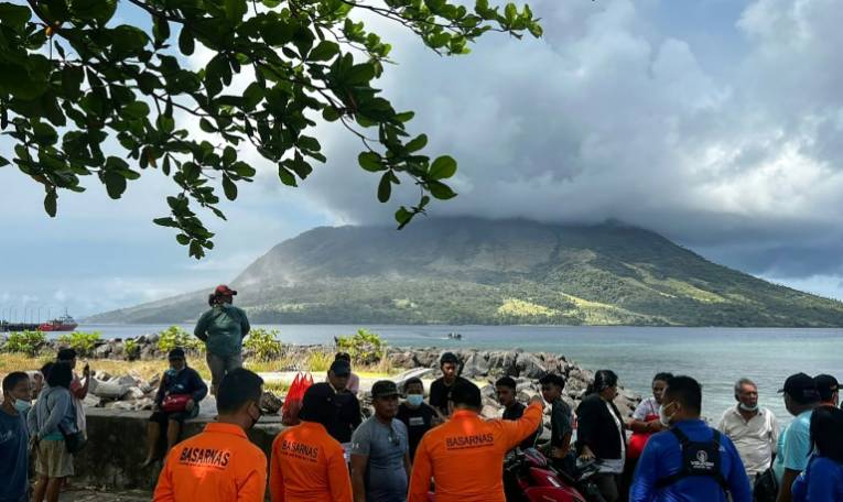 Photo diffusée par l'Agence nationale indonésienne de recherche et de sauvetage (BASARNAS), le 18 avril 2024, montrant des habitants de Sitaro observant le volcan Ruang en éruption, en Indonésie  ( National Search and Rescue Agency (BASARNAS) / Handout )