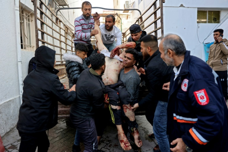 Des personnes portent un blessé à la suite d'une frappe israélienne à l'hôpital Al-Ahli, également connu sous le nom d'hôpital baptiste, dans la ville de Gaza, le 2 janvier 2025 ( AFP / Omar AL-QATTAA )