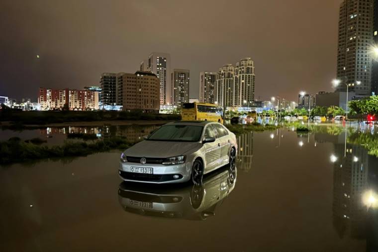 Des véhicules dans une rue inondée près des fortes pluies à Dubaï, le 17 avril 2024 ( AFP / Giuseppe CACACE )