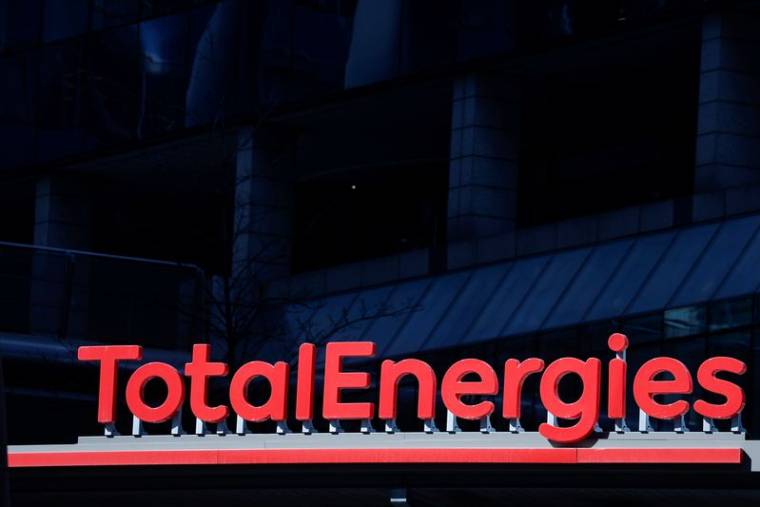 Signage for TotalEnergies at a gas station in the La Defense business district in Paris