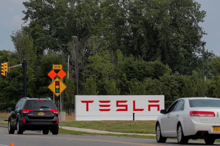 Cars pass by the Tesla Inc. Gigafactory 2, which is also known as RiverBend, a joint venture with Panasonic to produce solar panels and roof tiles in Buffalo, New York