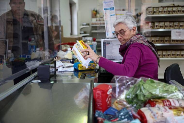 Une femme travaille à la caisse d'un supermarché