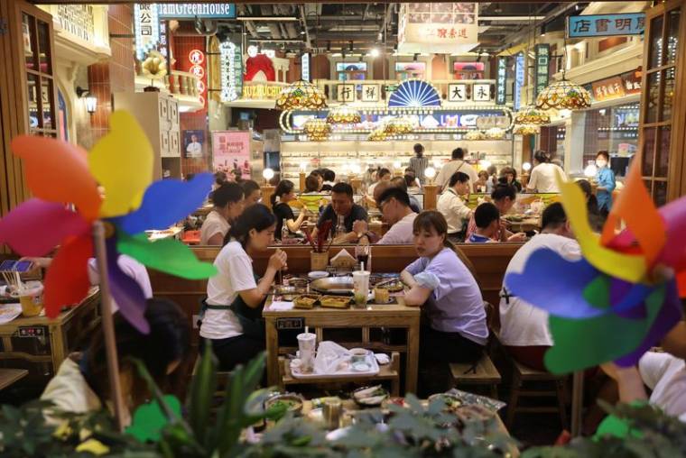 Des clients dînent dans un restaurant situé dans une zone commerciale de Pékin