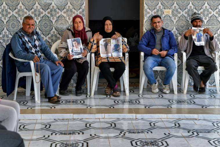 Des membres des familles de jeunes migrants tunisiens perdus en mer en janvier se rassemblent avec leurs photos à El Hencha, dans le centre de la Tunisie, le 23 avril 2024 ( AFP / FETHI BELAID )