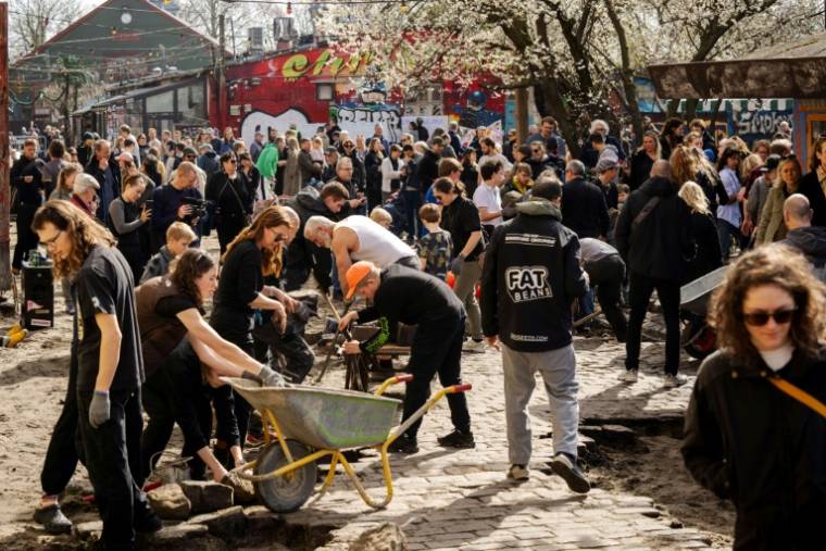 Des habitants du quartier de Christiania dépavent Pusher Street, l'artère principale de cet ancien paradis hippie niché au cœur de Copenhague, où le cannabis était en vente libre, le 6 mars 2024 ( Ritzau Scanpix / Ida Marie Odgaard )