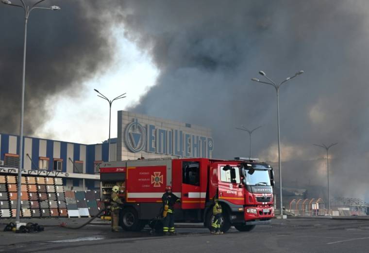 Des pompiers ukrainiens interviennent après un incendie dans un hypermarché touché par une frappe russe à Kharkiv, le 25 mai 2024 ( AFP / SERGEY BOBOK )