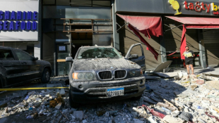 Une voiture détruite sur le site d'une frappe aérienne israélienne dans la banlieue sud de Beyrouth, le 26 septembre 2024 ( AFP / Ibrahim AMRO )