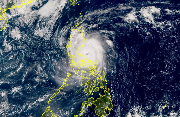 Image satellite colorisée publiée par l'agence météorologique japonaise (JMA) montrant le super typhon Man-yi en train de toucher terre sur l'île philippine de Luzon ( Japan Meteorological Agency / Handout )