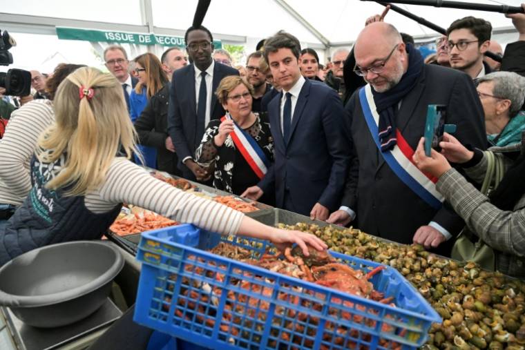 Le Premier ministre Gabriel Attal (C) lors de sa visite à la Foire aux Bulots à Pirou dans la Manche, le 27 avril 2024 ( AFP / DAMIEN MEYER )