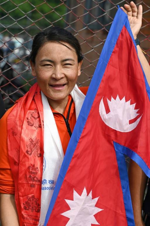 La guide et alpiniste népalaise Phunjo Lama, qui a battu le 23 mai 2024 le record d'ascension de l'Everest par une femme, est accueillie à l'aéroport de Katmandou, le 26 mai 2024.  ( AFP / Prakash MATHEMA )