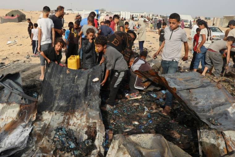 Des Palestiniens rassemblé sur le site d'une attaque israélienne contre un camp de personnes déplacées à Rafah, le 27 mai 2024 ( AFP / Eyad BABA )