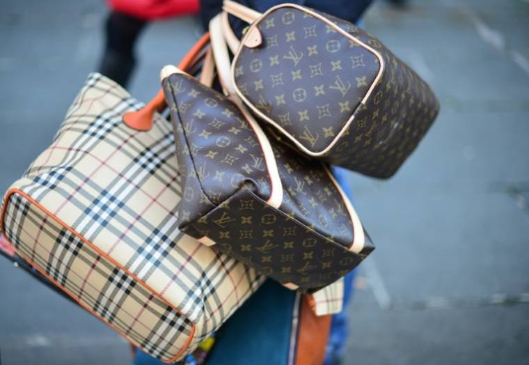 Face aux milliards d'euros de ventes de grandes marques comme Gucci et Prada, les contrefaçons de luxe dans les rues de Naples génèrent elles aussi un flux financier massif ( AFP / Gabriel BOUYS )