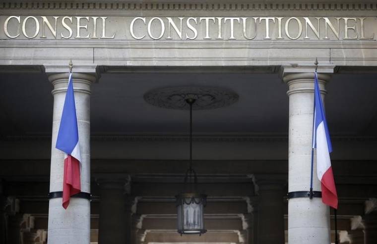 French flags hang outside the entrance of the Constitutional Council in Paris