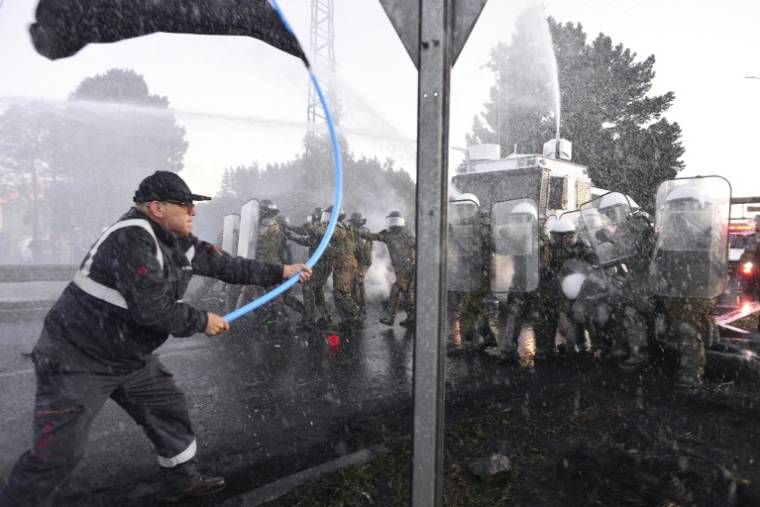 Des travailleurs de l'acier affrontent la police lors d'une manifestation contre la fermeture éventuelle de l'usine sidérurgique de Huachipato dans la ville de Talcahuano, au Chili, le 4 avril 2024 ( AFP / GUILLERMO SALGADO )