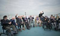 Des vétérans britanniques lors d'un voyage vers la France à bord du ferry Brittany Ferries, au large de Portsmouth, le 4 juin 2024, dans le cadre des commémorations du « jour J » ( AFP / Lou BENOIST )