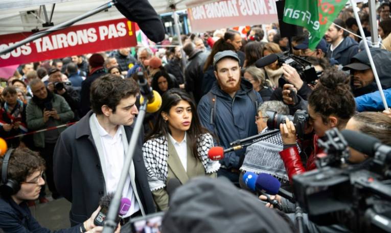 Rima Hassan s'adresse aux journalistes à côté de son avocat Vincent Brengarth (G) lors d'un rassemblement de soutien, à Paris le 30 avril 2024 ( AFP / Antonin UTZ )
