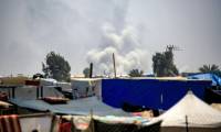 Un nuage de fumée s'élève dans le ciel près de tentes où habitent des déplacés à Rafah, le 4 juin 2024, à Rafah, dans le sud de la bande de Gaza, où une guerre oppose Israël au mouvement islamiste palestinien Hamas ( AFP / Eyad BABA )