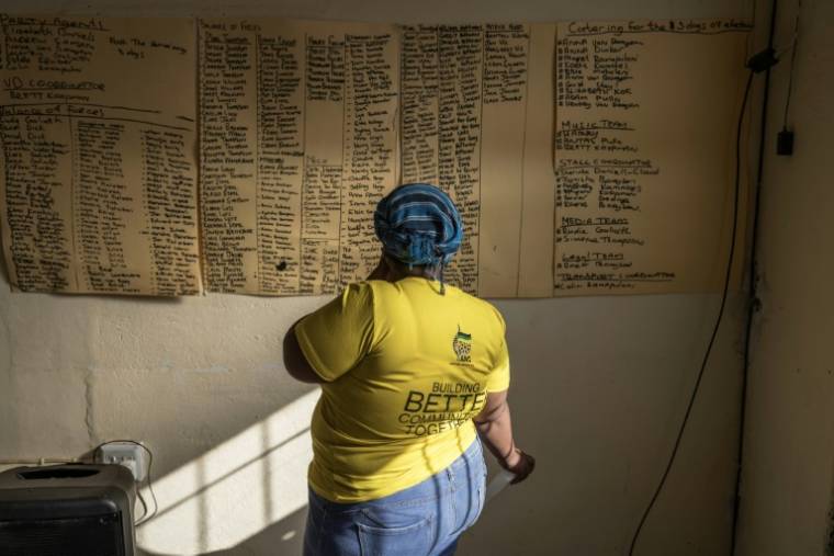 Une sympathisante du Congrès national africain (ANC) regarde une liste de noms pour une réunion de campagne à Philipstown, le 22 mai 2024 en Afrique du Sud ( AFP / MARCO LONGARI )