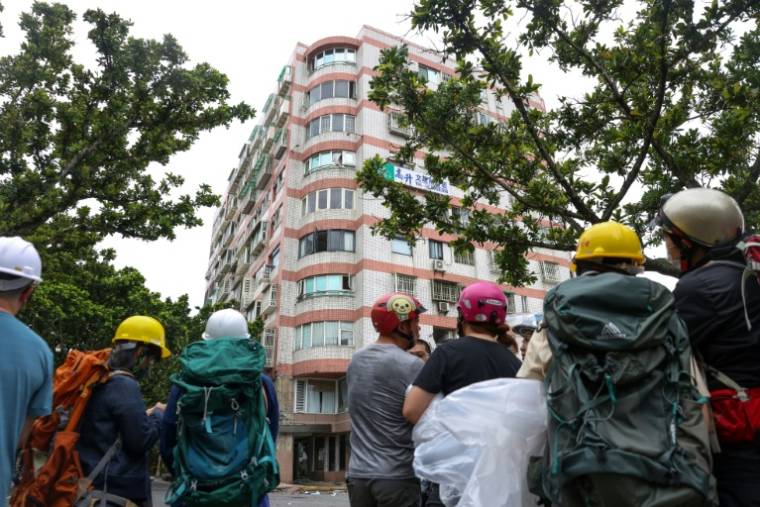 Des habitants s'apprêtent à récupérer leurs possessions dans leur immeuble endommagé par un séisme, le 5 avril 2024 à Hualien (Taïwan) ( AFP / I-Hwa CHENG )