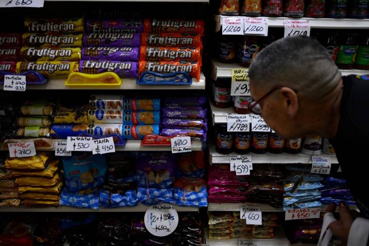 Une femme regarde les prix des denrées alimentaires dans un supermarché de Moron, province de Buenos Aires, Argentine, le 22 novembre 2023.  ( AFP / LUIS ROBAYO )
