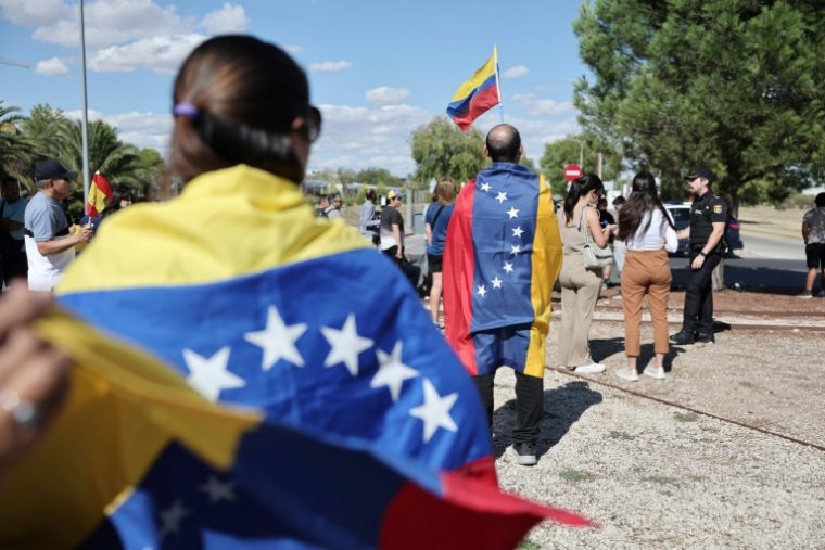 Des sympathisants portant des drapeaux du Venezuela attendent l'arrivée de l'opposant Edmundo Gonzalez Urrutia le 8 septembre 2024 à l'aéroport militaire Torrejon de Ardoz à Madrid ( AFP / Thomas COEX )