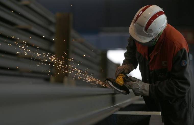 Sparks fly as an employee works on a rail at the Tata Steel rails factory in Hayange
