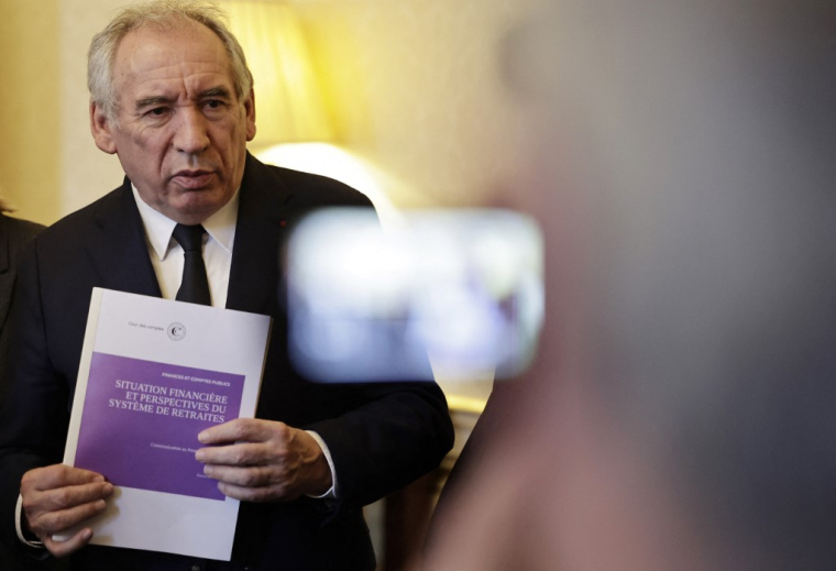 François Bayrou tenant le rapport de la Cour des Comptes sur le système de retraites, à Paris, le 20 février 2025. ( POOL / STEPHANE DE SAKUTIN )