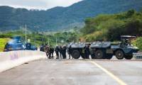 Des gendarmes mobiles sécurisent la zone pendant une opération de nettoyage de la route menant à l'aéroport de Nouméa dans le quartier de Païta, en Nouvelle-Calédonie, le 19 mai 2024 ( AFP / Delphine Mayeur )