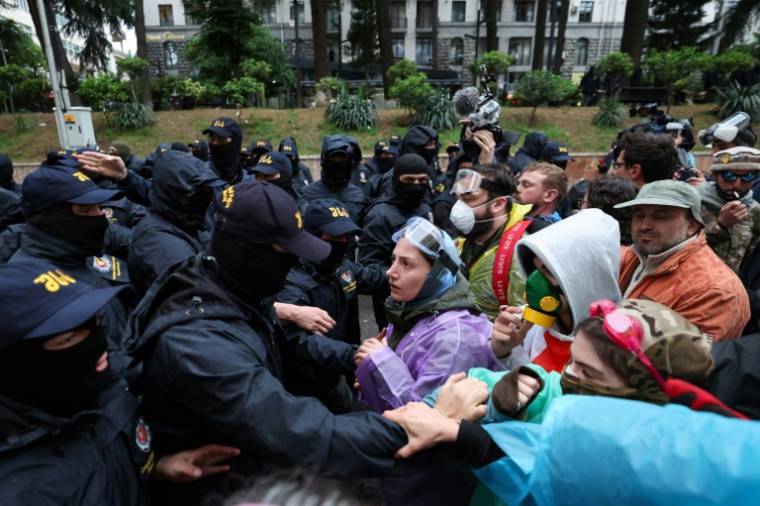 Des policiers bloquent des manifestants opposés au projet de loi controversé sur "l'influence étrangère" près du parlement à Tbilissi, le 13 mai 2024 en Géorgie ( AFP / Giorgi ARJEVANIDZE )