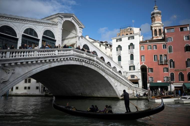 Des touristes sur le pont du Rialto à Venise, le 24 avril 2024 ( AFP / MARCO BERTORELLO )