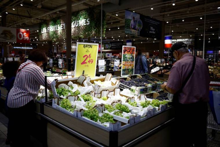 Des clients font leurs courses au rayon fruits et légumes d'un supermarché Carrefour à Montesson