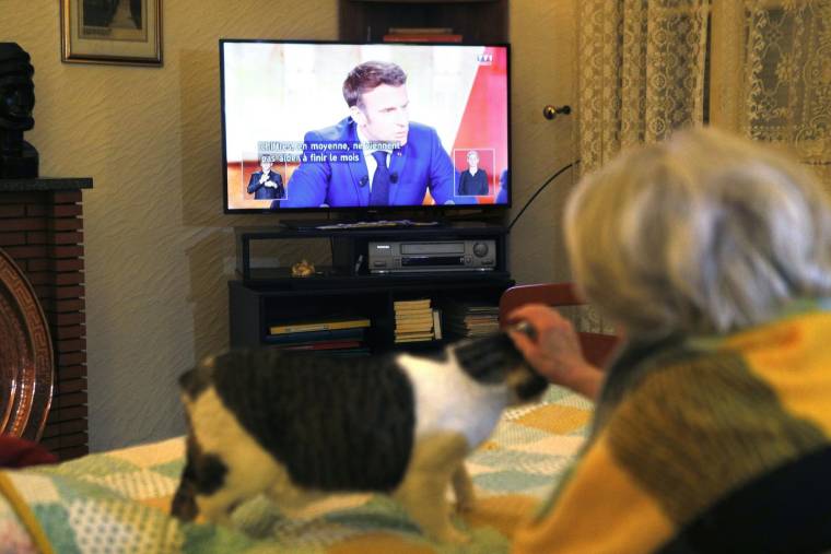 Une téléspectatrice devant le débat d'entre-deux-tours de la présidentielle, le 24 avril 2022, en Corse. ( AFP / Pascal POCHARD-CASABIANCA )