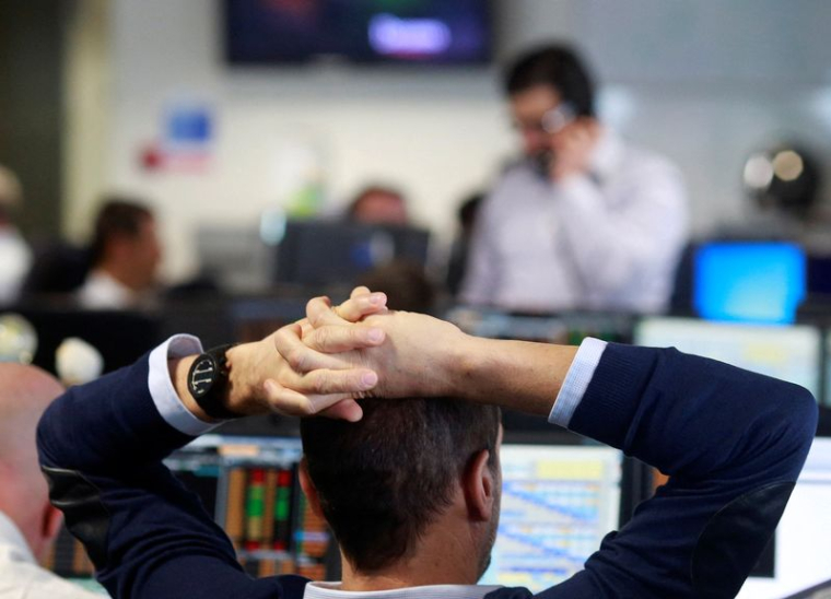 Traders from BGC Partners, a global brokerage company in London's Canary Wharf financial centre wait for European stock markets to open