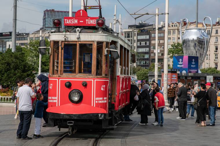 With the nostalgic tram standing in Taksim square, the 2023 UEFA Champions League giant trophy seen in the background. Manchester City and Inter will face each other in the final match that will determine the champion of the UEFA Champions League season on Saturday, June 10, 2023 at Ataturk Olympic Stadium. As part of the festival, a giant Champions League trophy and a model of a soccer ball were seen in Taksim. It was met with intense interest from domestic and foreign tourists. (Photo by Onur Dogman / SOPA Images/Sipa USA) - Photo by Icon sport