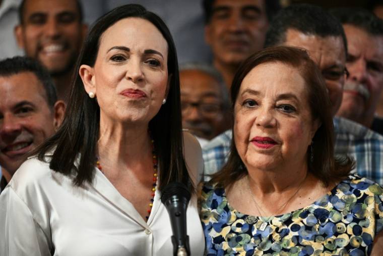 La leader de l'opposition Maria Corina Machado (g), déclarée inéligible à la présidentielle vénézuélienne, et sa remplaçante Corina yoris (d), lors d'une conférence de presse à Caracas, le 22 mars 2024  ( AFP / Federico Parra )