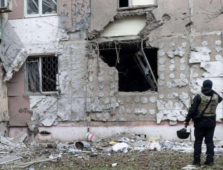 Un procureur ukrainien chargé des crimes de guerre inspecte un bâtiment résidentiel endommagé par une frappe militaire russe à Kherson