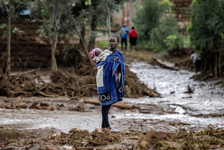 Une femme et son bébé dans une zone fortement touchée par des pluies torrentielles et des inondations à Mai Mahiu, le 29 avril 2024 au Kenya ( AFP / LUIS TATO )