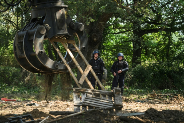 Des gendarmes pendant une opération d'évacuation d'un campement d'activistes opposés à la construction de l'autoroute A69, le 30 août 2024 à Saix, dans le Tarn ( AFP / Ed JONES )