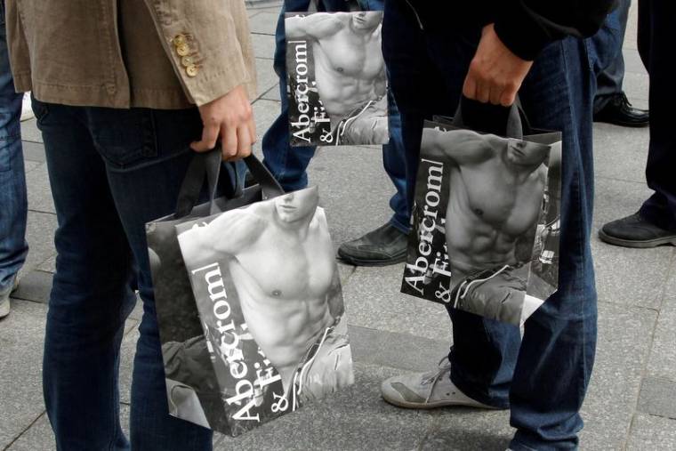 Des acheteurs tiennent des sacs d'Abercrombie & Fitch à l'extérieur du magasin parisien de la société sur les Champs Elysées