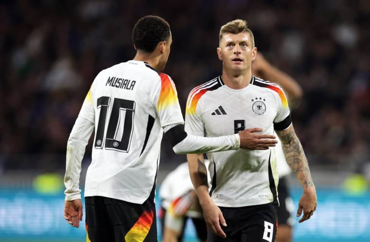 23 March 2024, France, Lyon: Soccer: International match, France - Germany, Groupama Stadium. Germany's players Jamal Musiala (l) and Toni Kroos react. Photo: Christian Charisius/dpa   - Photo by Icon Sport